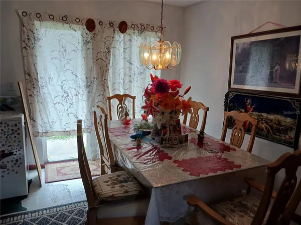 a view of a dining room with furniture and chandelier