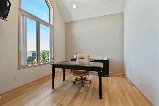 a view of a workspace with furniture and wooden floor