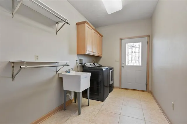 a view of storage and utility room with two washing machine