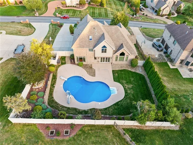 an aerial view of residential house with outdoor space and swimming pool