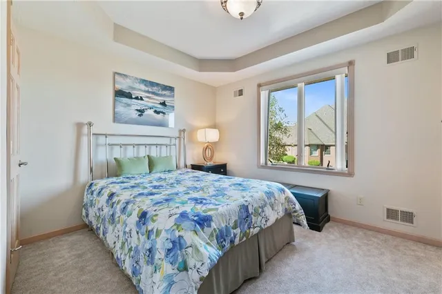 a bedroom with a bed and painting on the wall