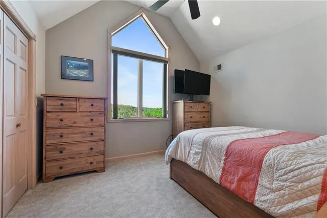 a bedroom with a bed and a television