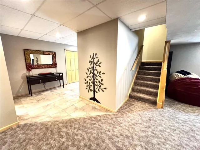 a view of a livingroom with wooden floor and furniture