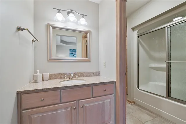 a bathroom with a sink vanity and mirror