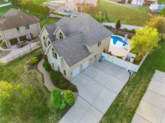 an aerial view of a house with a yard basket ball court and outdoor seating