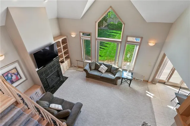 a living room with furniture a window and a flat screen tv