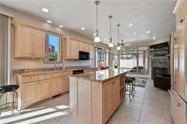 a kitchen with stainless steel appliances kitchen island granite countertop a sink and cabinets