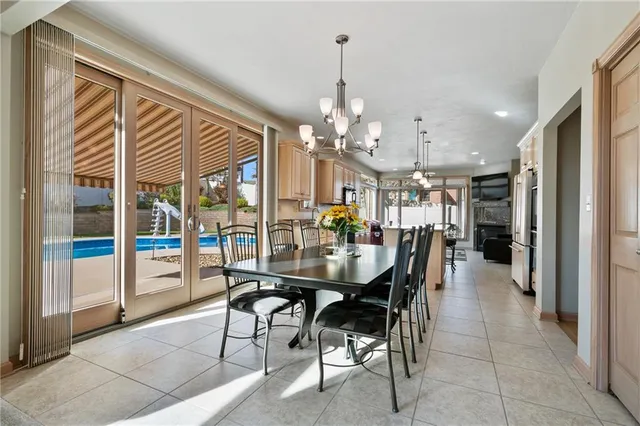 a dining area with furniture and a chandelier