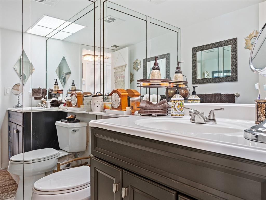 501 North Riverside Drive, Unit 601 Pompano Beach, FL 33062 - Photo 13 of 32 a bathroom with a double vanity sink toilet mirror and tub