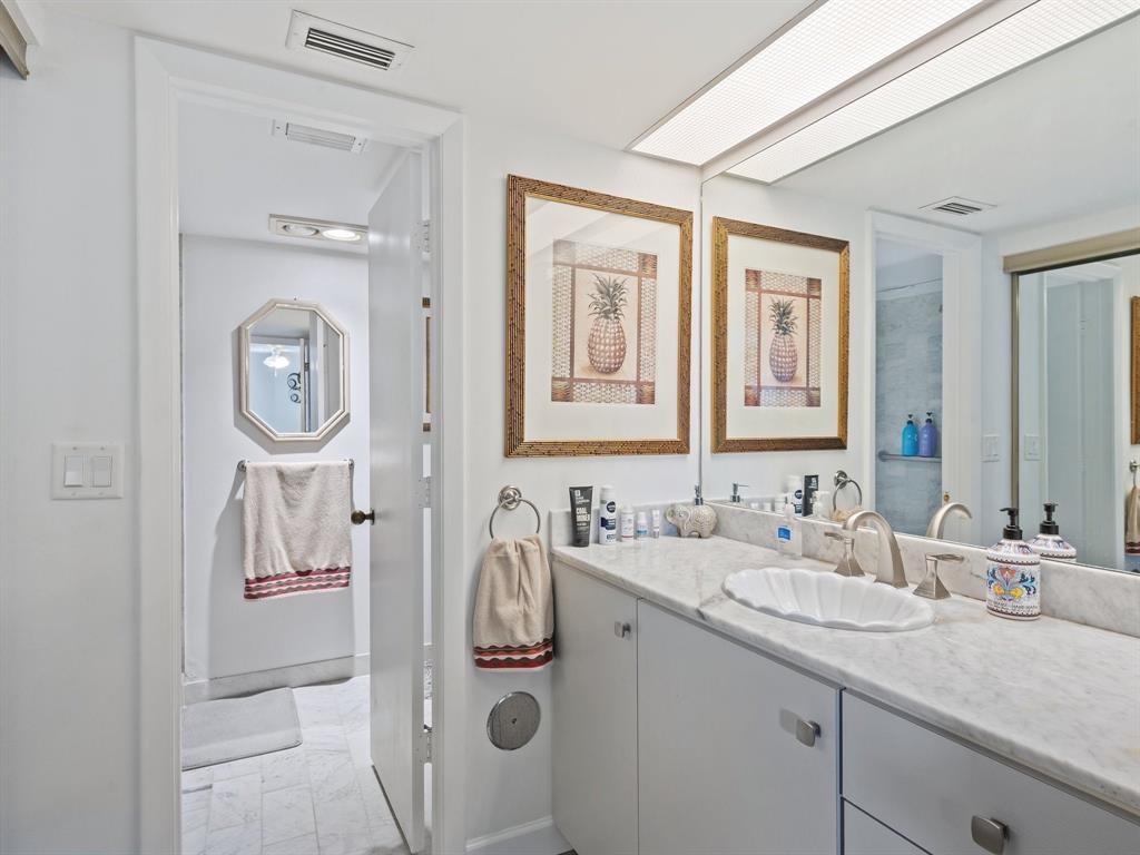 501 North Riverside Drive, Unit 601 Pompano Beach, FL 33062 - Photo 26 of 32 a bathroom with a sink vanity and mirror
