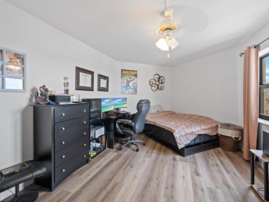 501 North Riverside Drive, Unit 601 Pompano Beach, FL 33062 - Photo 28 of 32 a bedroom with a bed and wooden floor