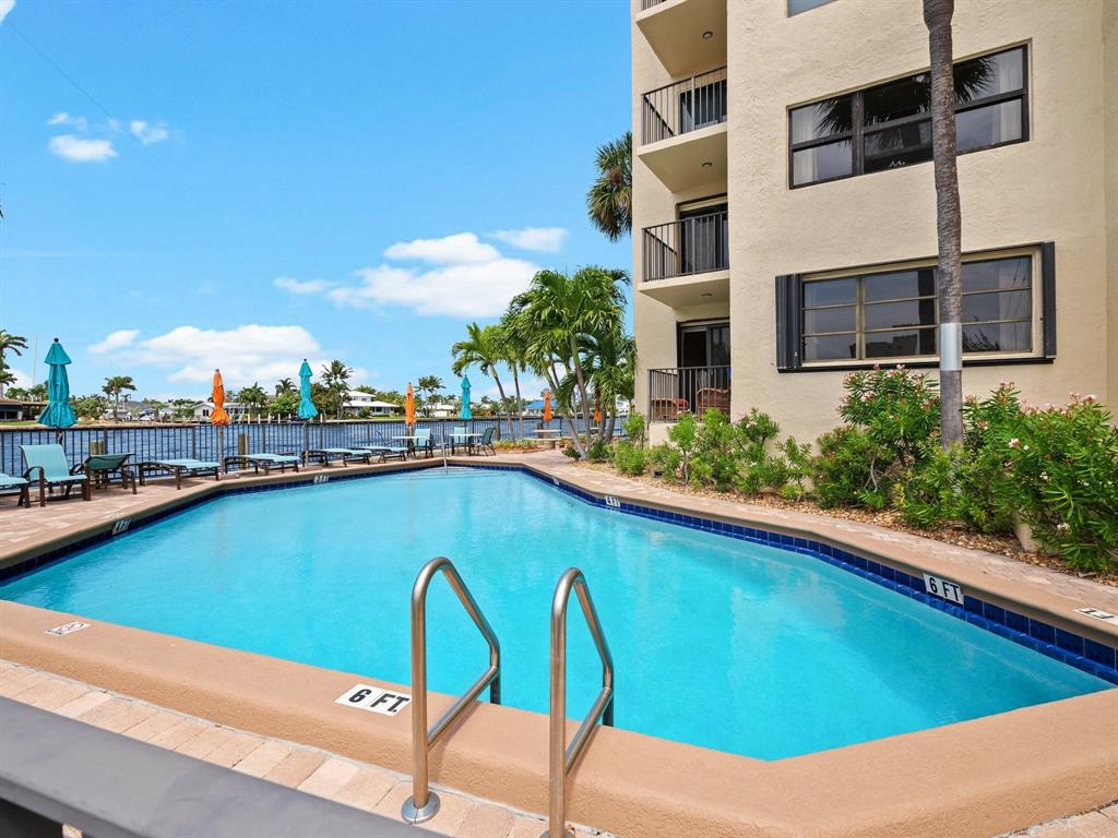 501 North Riverside Drive, Unit 601 Pompano Beach, FL 33062 - Photo 3 of 32 a view of a swimming pool with a lounge chairs
