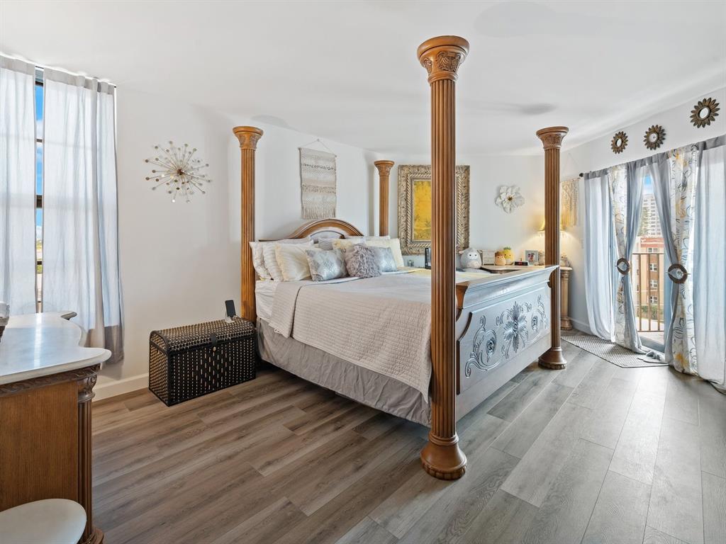 501 North Riverside Drive, Unit 601 Pompano Beach, FL 33062 - Photo 31 of 32 a bedroom with a bed and a chandelier