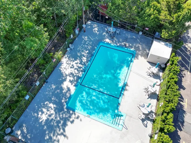 an aerial view of a house with a yard and trees