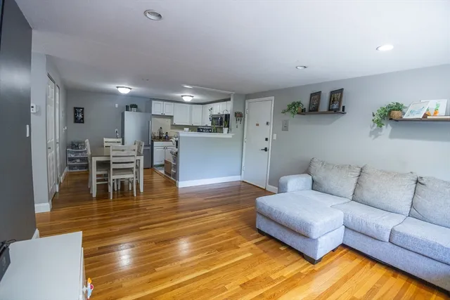 a living room with furniture and kitchen view