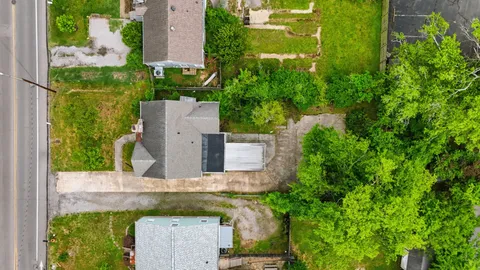 an aerial view of a house with a yard