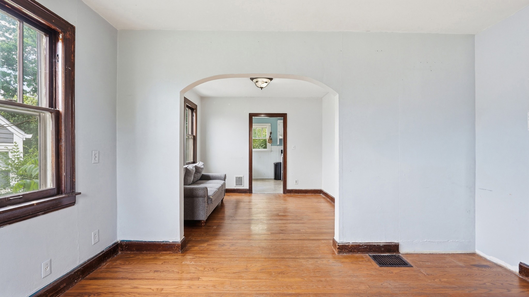 1603 Porter Road Nashville, TN 37206 - Photo 4 of 21 a view of a hallway with wooden floor and a bathroom