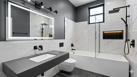 a bathroom with a sink a toilet and bathtub