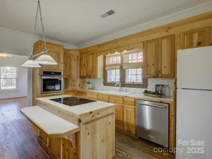 a kitchen that has a sink and a stove in it