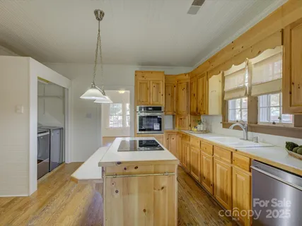a kitchen with a sink stove and refrigerator