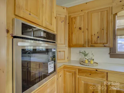 a kitchen with stainless steel appliances granite countertop a stove a microwave and cabinets