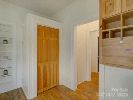 a view of walk in closet with empty room