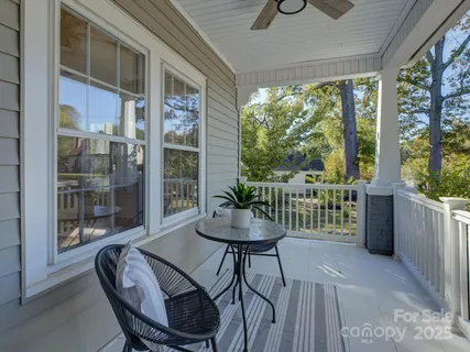 a view of a dining room with furniture wooden floor and a potted plant