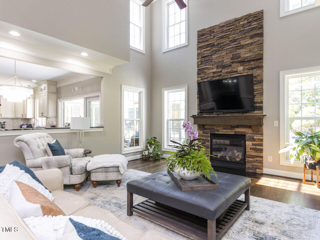 1201 Kalworth Road Wake Forest, NC 27587 - Photo 18 of 76 a living room with furniture a fireplace and a flat screen tv