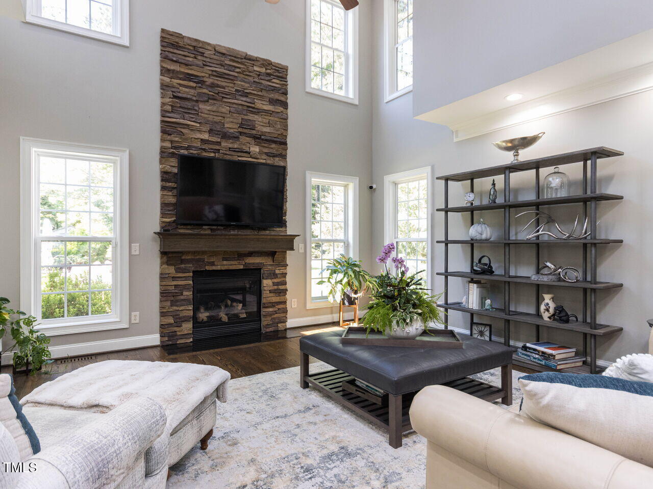1201 Kalworth Road Wake Forest, NC 27587 - Photo 20 of 76 a living room with furniture a flat screen tv and a fireplace