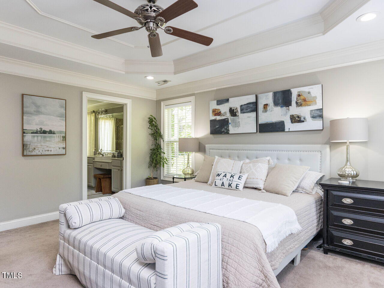1201 Kalworth Road Wake Forest, NC 27587 - Photo 25 of 76 a bedroom with a large bed and a chandelier