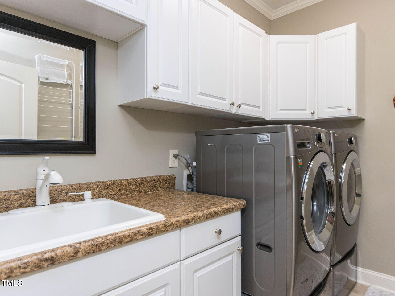1201 Kalworth Road Wake Forest, NC 27587 - Photo 31 of 76 a bathroom with washing machine and sink
