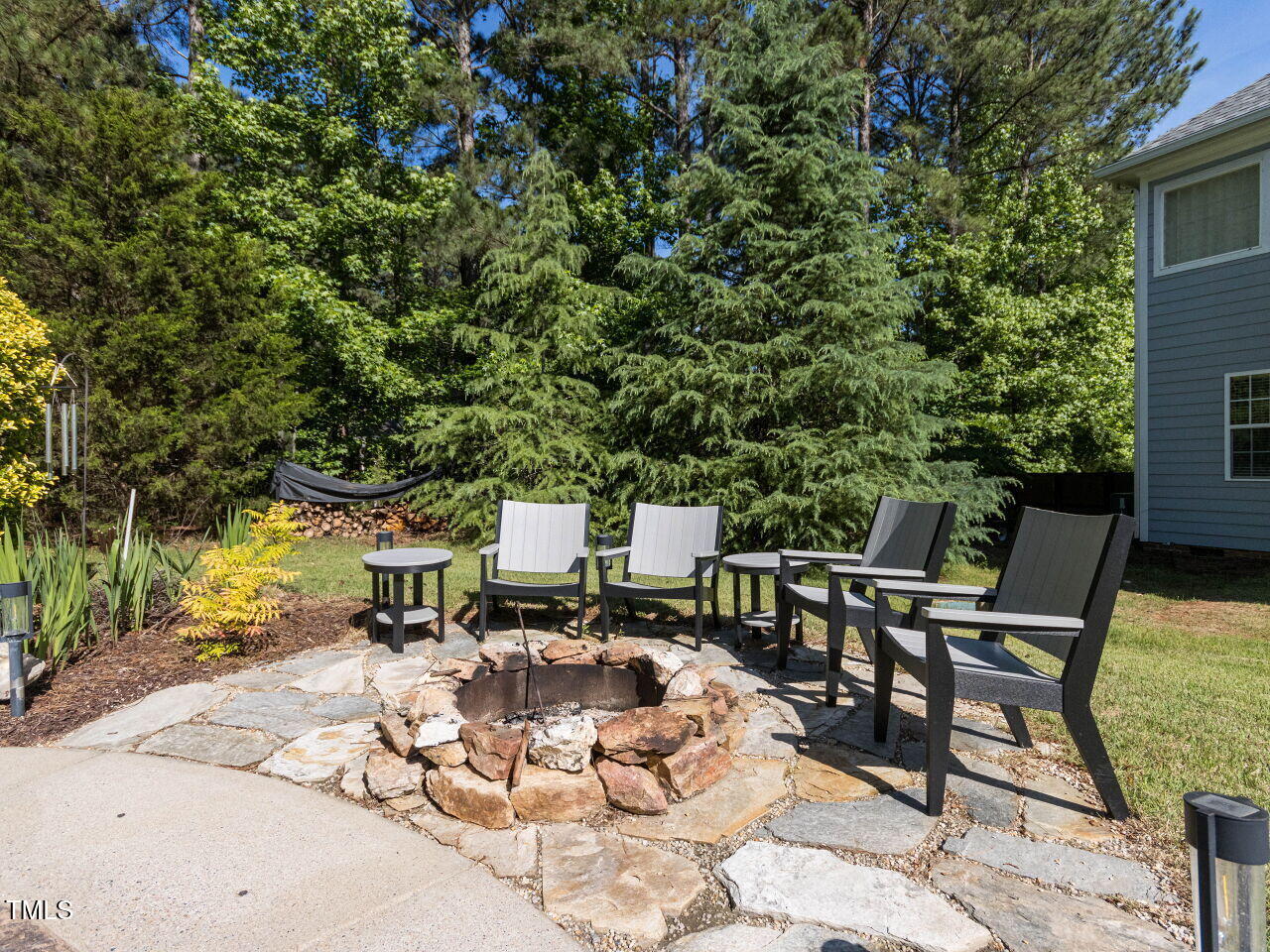 1201 Kalworth Road Wake Forest, NC 27587 - Photo 50 of 76 a view of a patio with table and chairs with wooden fence and plants