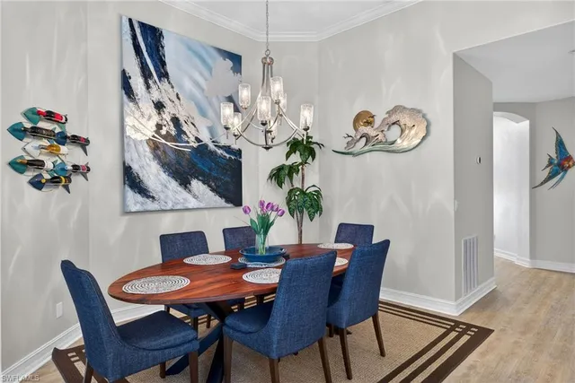 a view of a dining room with furniture wooden floor and a chandelier