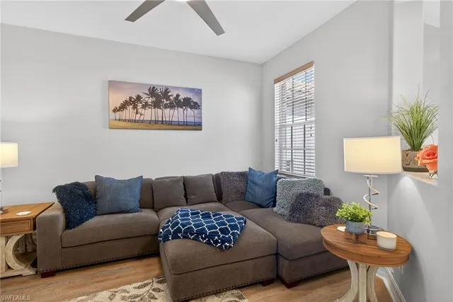 a living room with furniture a couch and a potted plant