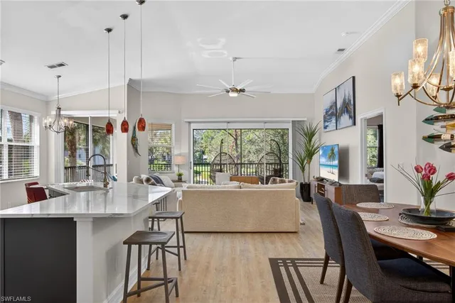 a living room with furniture a chandelier and a large window