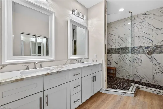 a bathroom with a double vanity sink and mirror