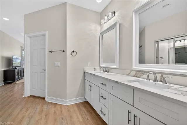 a spacious bathroom with a double vanity sink mirror and