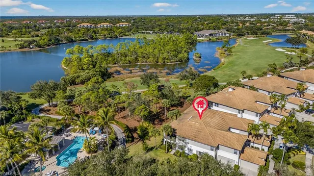 an aerial view of residential houses with outdoor space and river