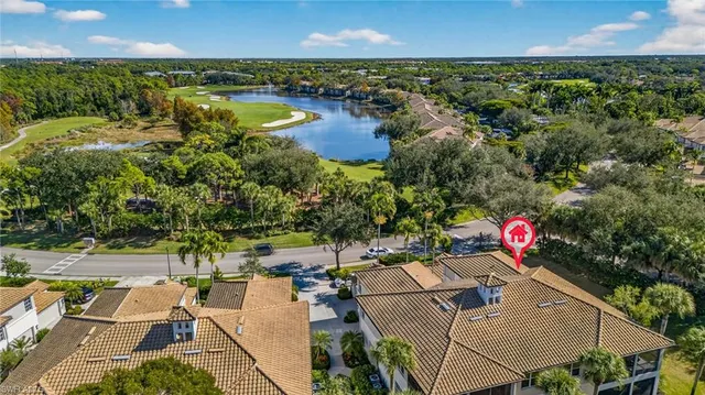 an aerial view of residential houses with outdoor space and lake view