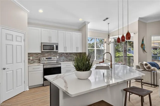 a kitchen with a stove a sink and a refrigerator