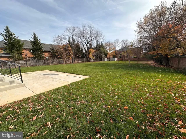 a swimming pool with trees in the background