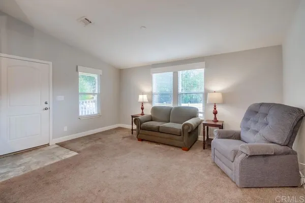 a living room with furniture and windows