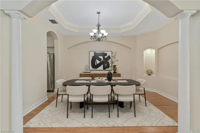 a view of a a dining room with furniture and wooden floor