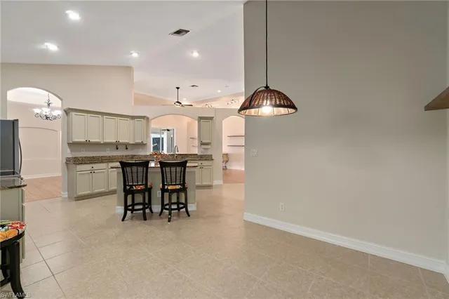 a kitchen with cabinets and chairs