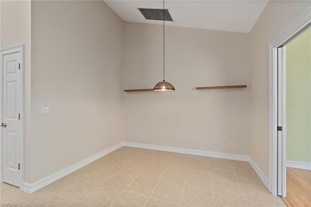 1158 Oakes Boulevard Naples, FL 34119 - Photo 17 of 40 Unfurnished dining area with high vaulted ceiling and light flooring