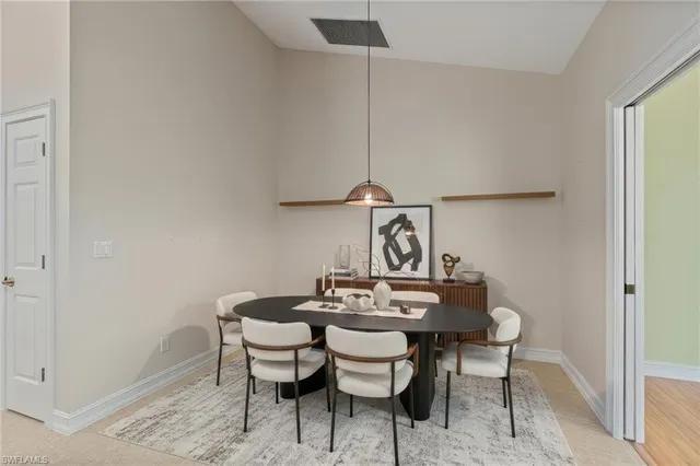 a view of a dining room that has a table and chairs in it