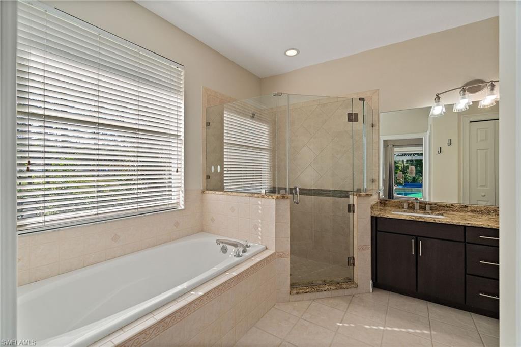 1158 Oakes Boulevard Naples, FL 34119 - Photo 25 of 40 Main Bathroom featuring vanity, a bathtub, a shower stall, light tile patterned flooring, and recessed lighting