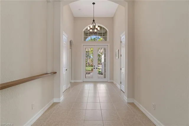 a hallway with sliding door and chandelier
