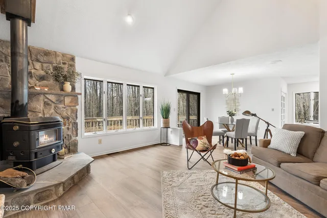 a dining room with wooden floor a glass table and chairs