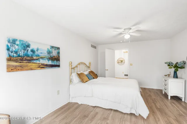 swimming pool view with hardwood floor and fence